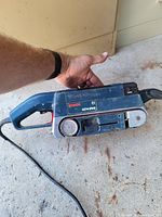 Side view showing Bosch 1274 DVS belt sander and power cord