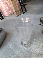 Overall view of clear acrylic vase on pedestal base