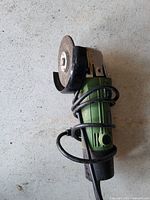 Angle grinder showing body, disc, guard and cord