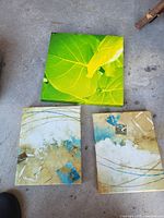 All three canvases displayed: square green leaf piece above two matching abstract pieces