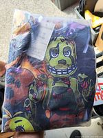 Factory-sealed hoodie package showing animatronic graphic