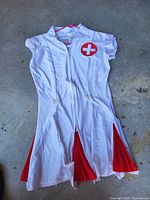 Full view of nurse costume dress showing color, design, and zipper