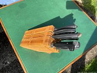 Side view of wooden block with knives inserted