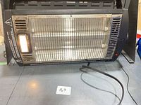 Front view of heater showing grill, light and power cord