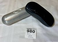 Silver metal eyeglass case and black Ray-Ban case closed