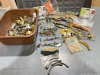 Overall view of mixed hardware lot with bin and loose items