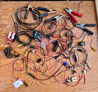 Overview of entire lot spread on table showing wires, clamps, fuse block and switches
