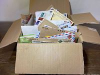 Full box filled with assorted stamped envelopes and covers
