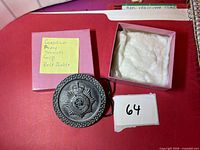 Buckle, presentation box, padding visible