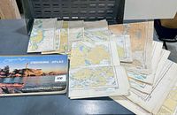 Top view of cruising atlas and spread of folded charts