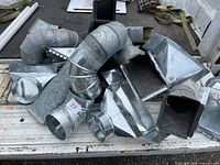 Pile of mixed galvanized elbows, boots and transitions on truck bed