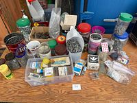 Overview of table with jars, tins, organizer box, mixed fasteners