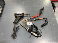 All four soldering tools and solder spool on table