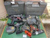 Full lot view showing drills, chargers, battery packs and two Craftsman cases