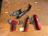 All five power tools and accessory bit sets displayed on tabletop