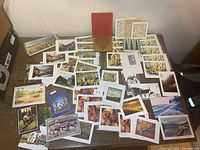 Full lot spread of assorted cards and prints on table