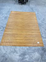 Full view of rectangular bamboo mat on concrete floor