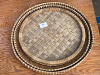 Three nested round bamboo trays showing size gradation and rim detail
