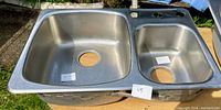 Top view of entire double-bowl sink showing bowls and mounting rim