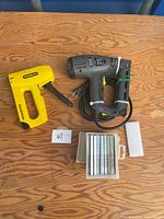 Both Stanley tackers, box of staples on table