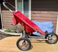 Side profile showing whole stroller, frame, wheels, seat