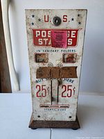 Front view showing graphics, coin slots, license decal and wood base