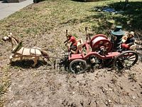 Full view of horse-drawn fire engine model in yard