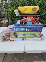 Stacked view of all five games plus loose components bag on table
