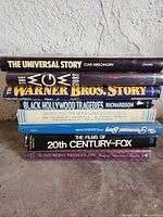 Stacked view of all eight hardcovers showing spines and titles