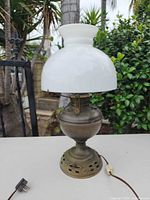 Full view of brass oil lamp with milk-glass shade