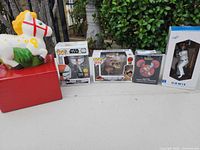Group shot of all five items: two Funko Pops, Mickey vinyl figure, Dodgers bobblehead, ceramic horse bank