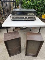 Stereo unit on table with both speakers in front