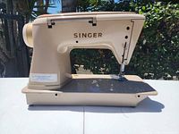Left side profile showing overall body, Singer logo, table bed