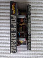 Front angled view of sealed Pop's Garage box with five cars visible