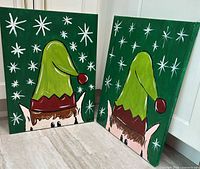 Both canvas paintings standing side by side showing complete artworks