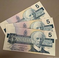 Fronts of the three 1986 $5 bills showing portrait and serial numbers