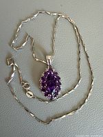 Full view of sterling chain and amethyst pendant