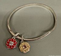 Bangle bracelet with two flower charms front view showing colors and design