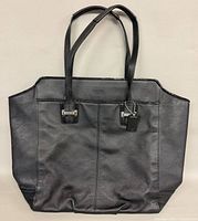 Front view of black Coach Taylor Alexis Carryall tote showing overall design and handles