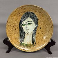 Front view of speckled glaze plate with portrait