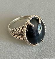 Ring angled view showing onyx stone and basket band