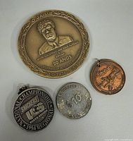 Group shot of all four medals/tokens