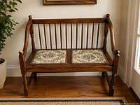 front view of full bench showing spindles, arms, and two cushions