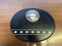 Top view showing dial, brand, shape and decoration