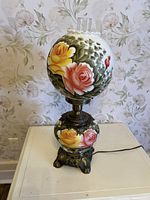 Full view of lamp showing both painted glass globes and metal base
