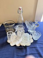 Group view of all clear glass items and doily