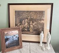 Overall lot view: framed engraving, poem print, two tall figurines, small nativity pieces