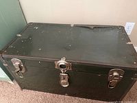 Closed trunk front showing latches and hasp