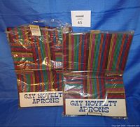 Both packaged aprons showing labels and pattern