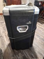 Front view showing Fellowes logo, pull-out bin handle, full housing